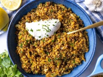 Step 4 Finished lentils and quinoa skillet served in a bowl topped with parsley and yogurt before serving.