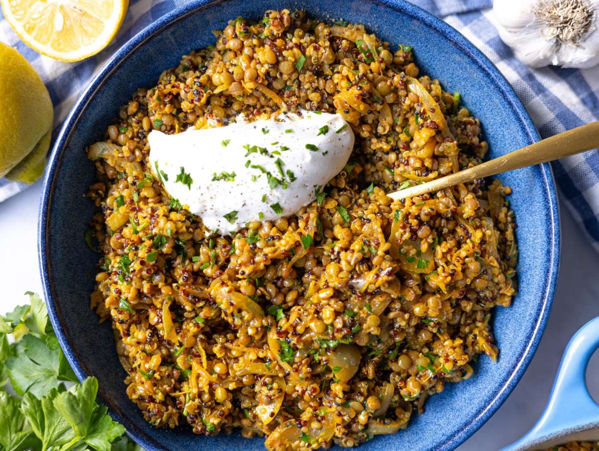 Step 4 Finished lentils and quinoa skillet served in a bowl topped with parsley and yogurt before serving.