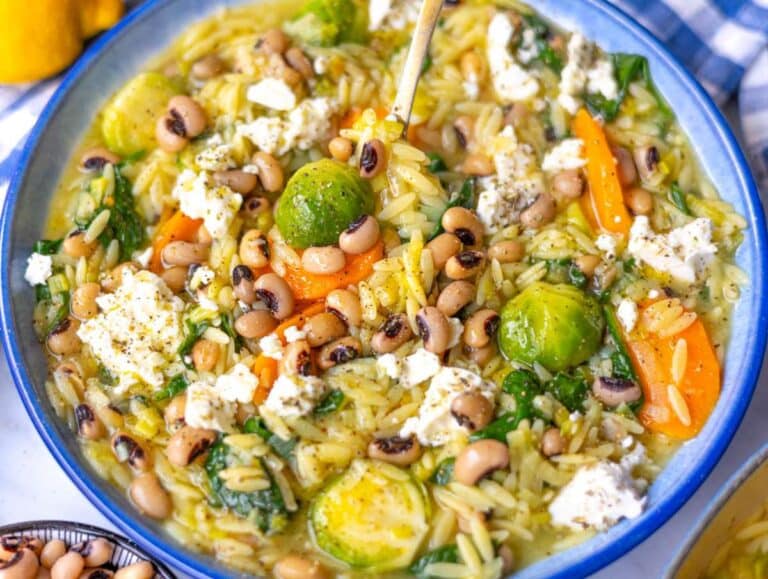 Step 4 Finished one pot vegetable orzo served in bowls topped with feta and olive oil.