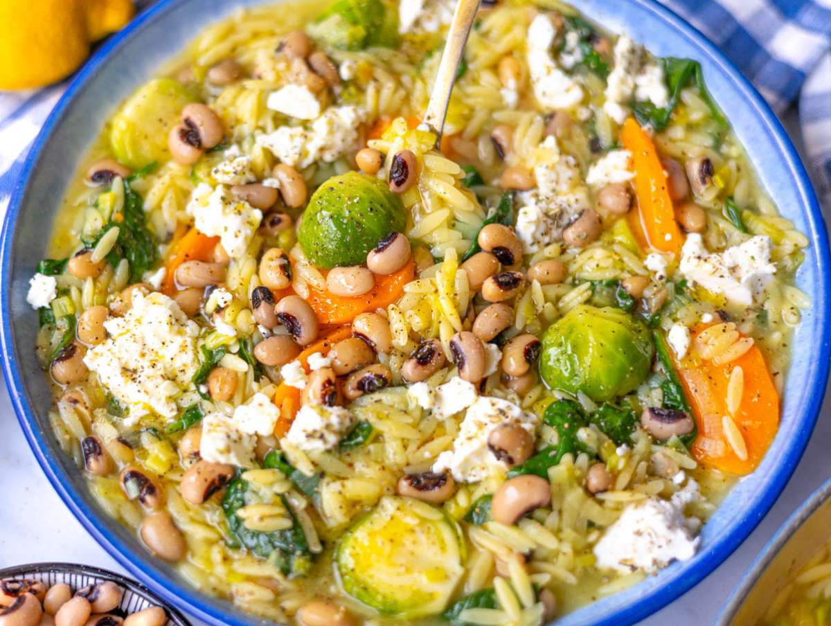 Step 4 Finished one pot vegetable orzo served in bowls topped with feta and olive oil.