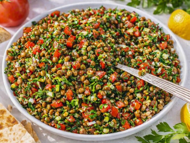 Step 4 Mixing lentils herbs and tomatoes into a fresh Mediterranean style salad.