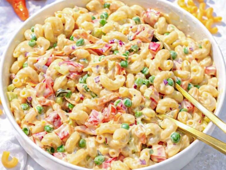 Step 4 Mixing pasta vegetables and dressing for creamy pasta salad without mayo overload.