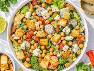 Step 4 Tossing pita salad with dressing feta and crunchy pita chips just before serving.