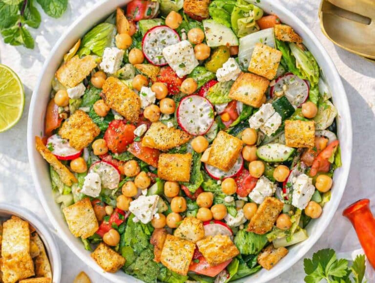 Step 4 Tossing pita salad with dressing feta and crunchy pita chips just before serving.