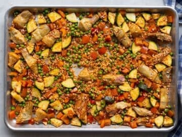 Step one Veggies rice and spices mixed on sheet pan.