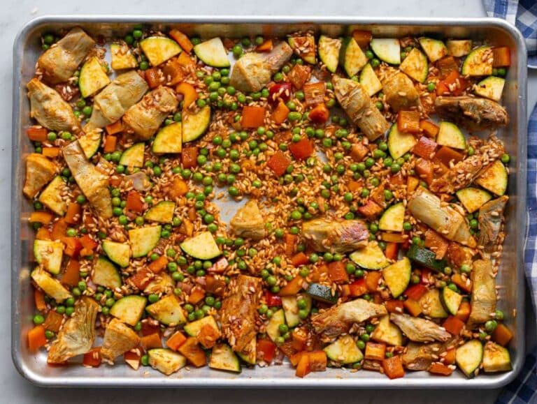 Step one Veggies rice and spices mixed on sheet pan.