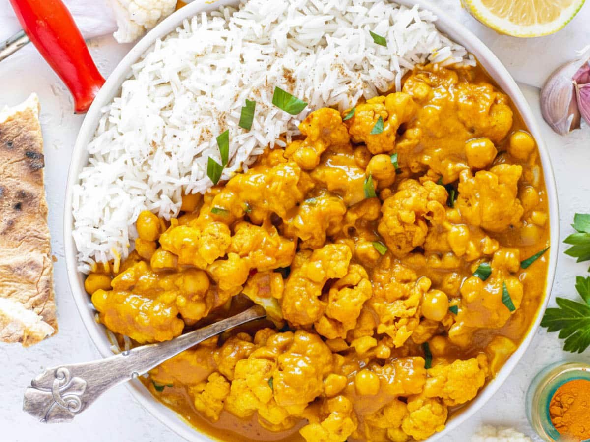 cauliflower curry recipe with a spoon.