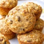 Apple sauce muffins stacked casually on a table ready for breakfast.