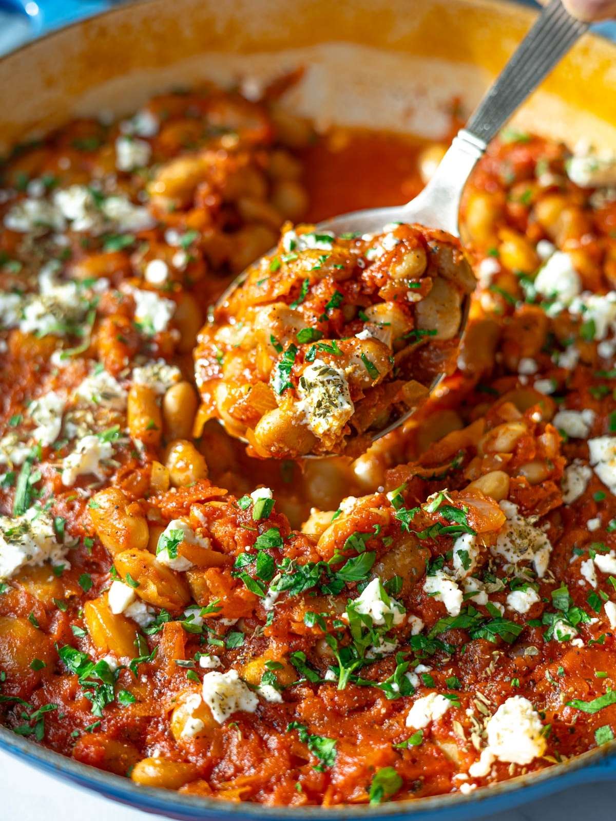 Baked butter beans in rich tomato sauce topped with feta and herbs.