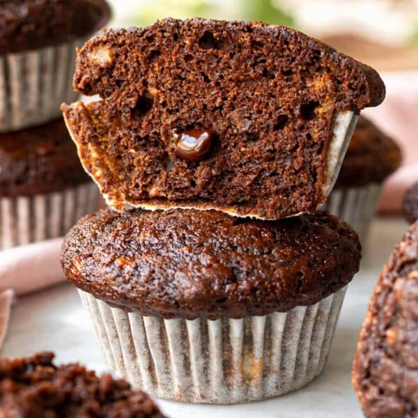 Banana chocolate muffins arranged on a marble table showing tender crumb.