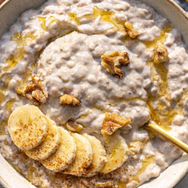 Banana overnight oats served simply in a bowl with spoon and soft morning light.