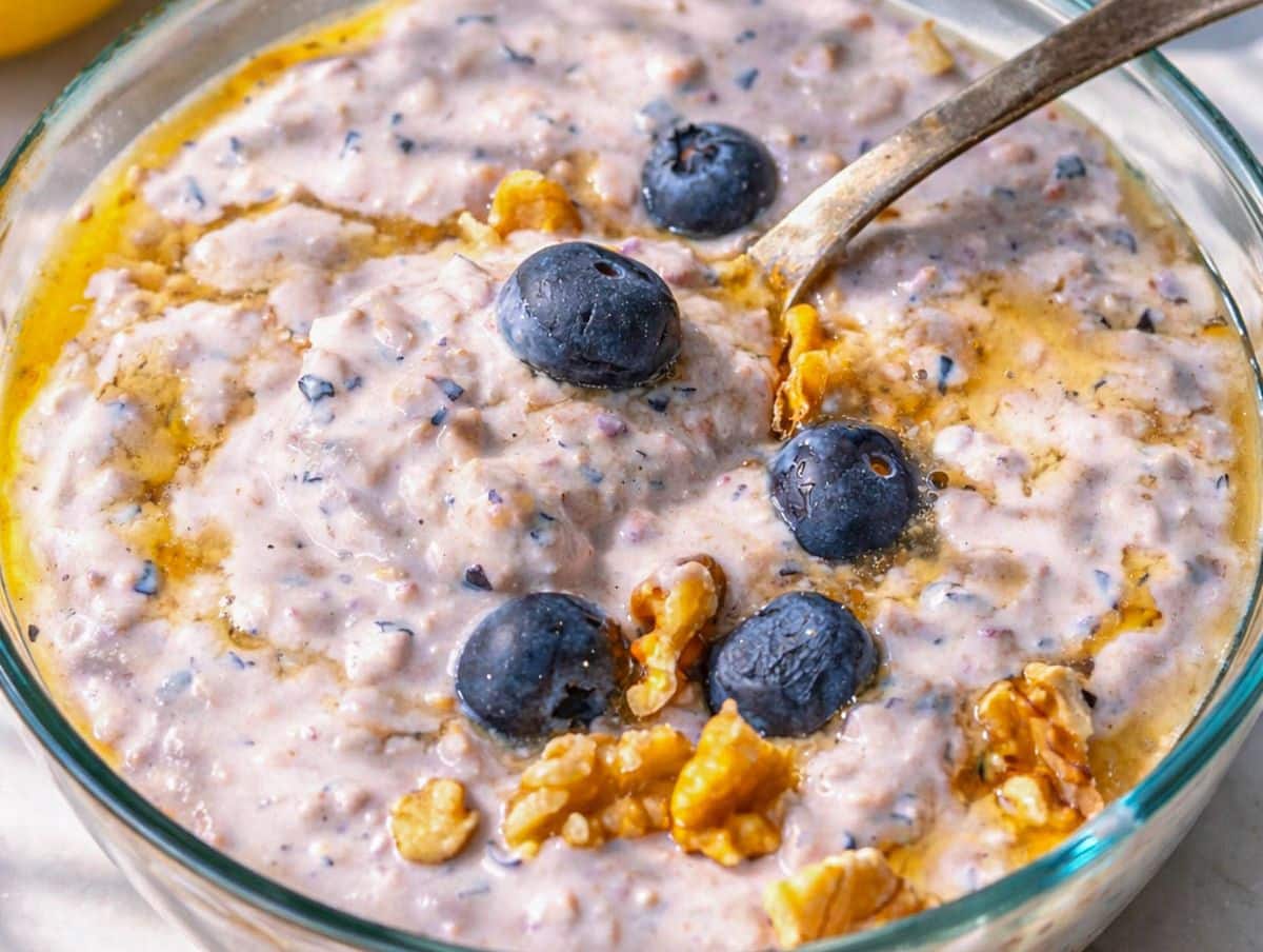 Blueberry overnight oats served in a simple bowl with spoon, ready to eat from the fridge.