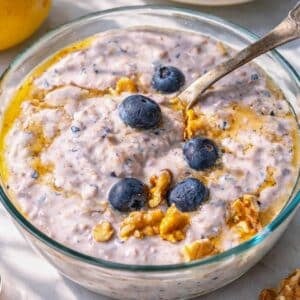 Bright bowl of blueberry overnight oats on a sunlit table with Mediterranean kitchen feel.
