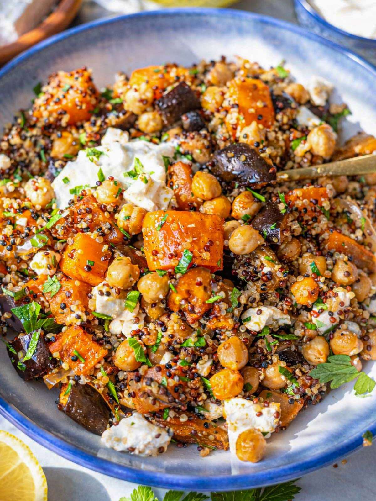 Close-up of roasted chickpeas and vegetables showing golden edges, spices, and creamy textures.