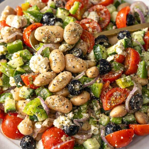 Colorful Greek Bean Salad close up bright vegetables and feta ready to eat.