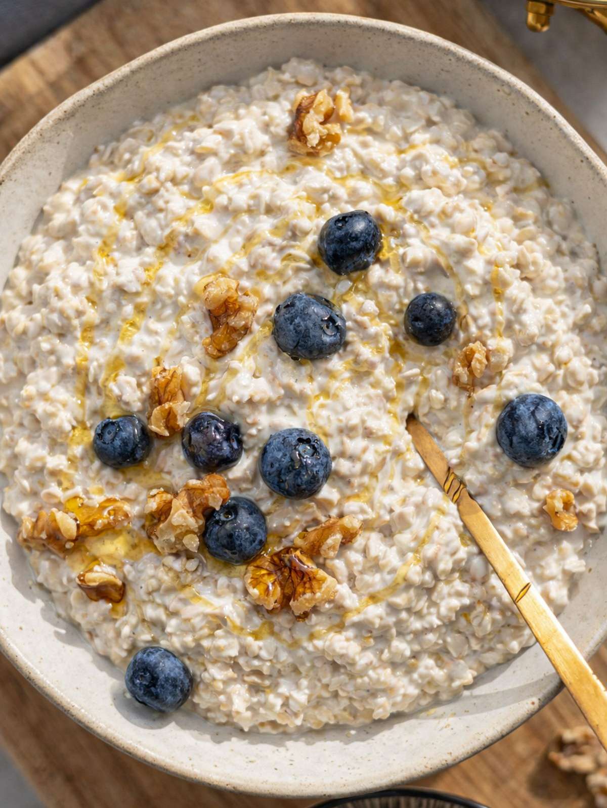Finished Greek yogurt overnight oats topped with berries and nuts in a simple bowl.