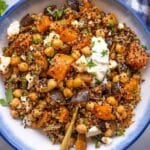 Finished chickpea shawarma bowl on the table with Greek yogurt, lemon and herbs, ready to eat.