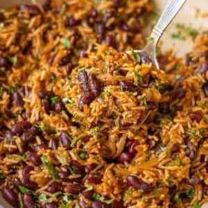 Kidney beans and rice skillet with caramelized onions, warm spices, and fresh parsley.