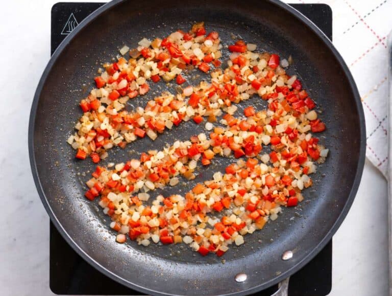 Step 1 Beans onions and red bell pepper cooking together in olive oil in a wide skillet.