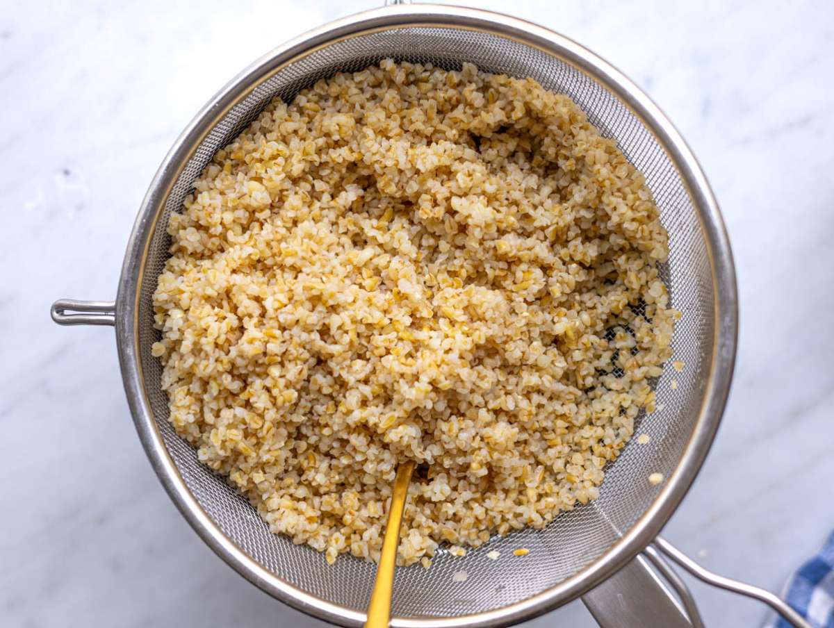 Step 1 Boiled bulgur draining over a pot.