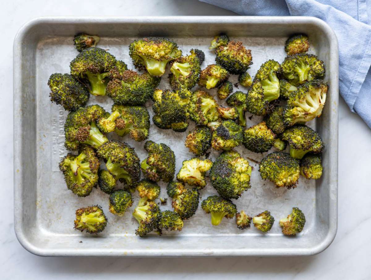 Step 1 Broccoli florets roasted until golden on a baking sheet with olive oil and salt.