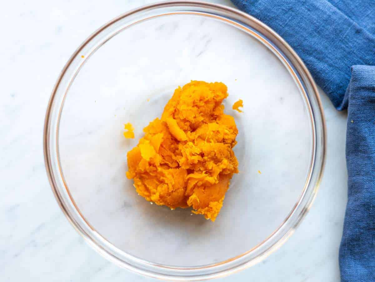Step 1 Microwaved sweet potato flesh mashed in a mixing bowl.