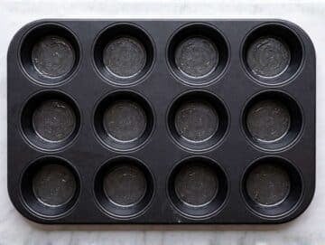 Step 1 Oiled muffin pan on counter while oven is preheating.