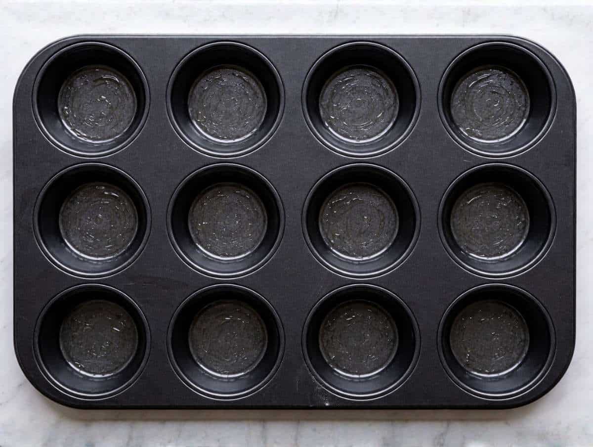 Step 1 Oiled muffin pan on counter while oven is preheating.