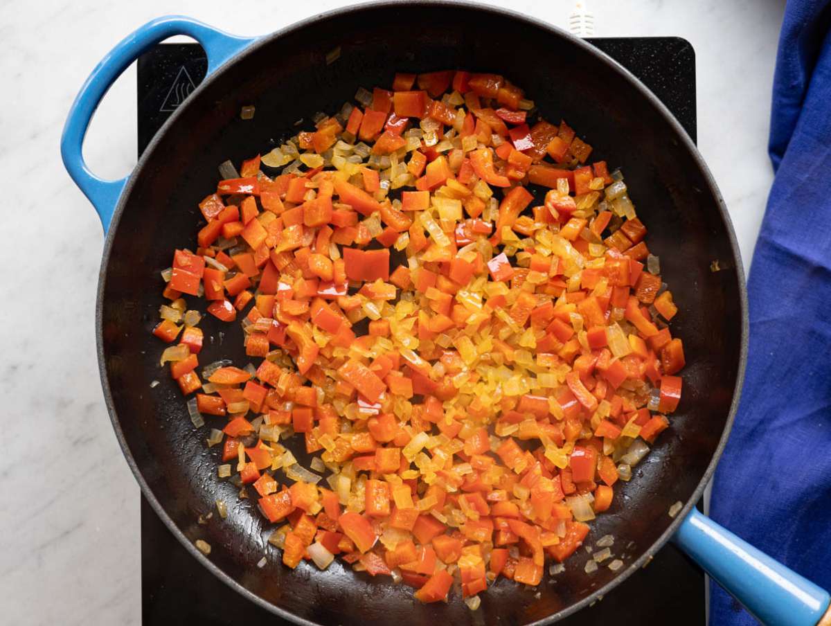 Step 1 Onion and red pepper sautéing in olive oil until soft and lightly golden.