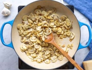 Step 1 Sliced mushrooms browning in a skillet with olive oil.