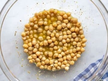 Step 2 Chickpeas tossed in lemon olive oil dressing inside a large mixing bowl.