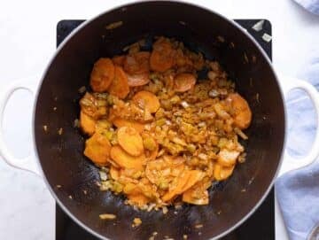 Step 2 Garlic and spices blooming in the pot with softened vegetables.