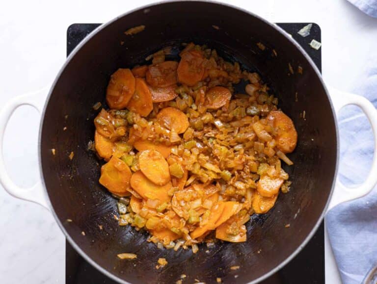 Step 2 Garlic and spices blooming in the pot with softened vegetables.