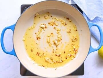 Step 2 Garlic gently sizzling in olive oil in a skillet over low heat.