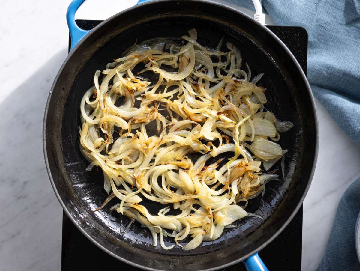 Step 2 Sliced onions cooking slowly in olive oil until soft and lightly golden.