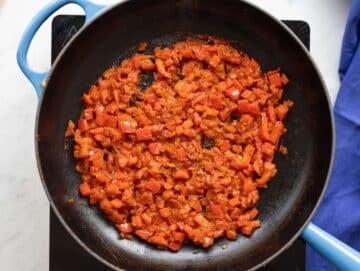 Step 2 Tomato paste and spices cooking in the skillet, darkened and fragrant.