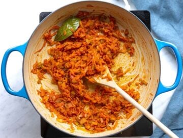 Step 2 Tomato paste garlic oregano and bay leaf stirred into softened vegetables.