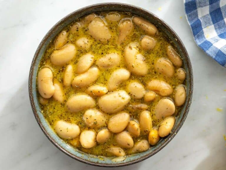 Step 2 White beans resting in dressing, soaking up flavor in a small bowl.