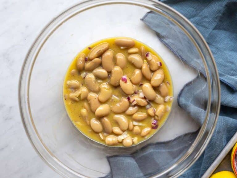 Step 3 Butter beans and red onion marinating in lemon dressing in a large bowl.
