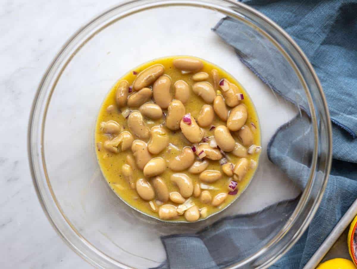 Step 3 Butter beans and red onion marinating in lemon dressing in a large bowl.