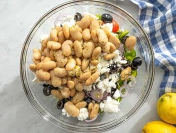 Step 3 Chopped vegetables and olives added to marinated beans with crumbled feta.
