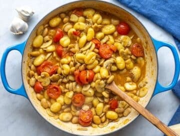 Step 3 Gnocchi simmering in vegetable broth with mushrooms and tomatoes, cooking directly in the skillet.