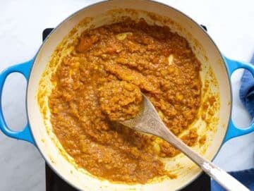 Step 3 Tomatoes simmering down into a thick sauce before adding lentils.
