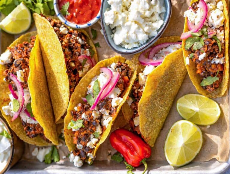 Step 4 Assembled tacos with black bean filling feta Greek yogurt and lime ready to eat.