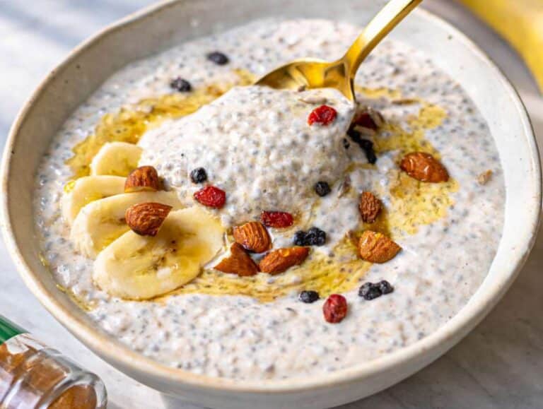 Step 4 Banana chia pudding served in a bowl with fresh banana, almonds, and honey.