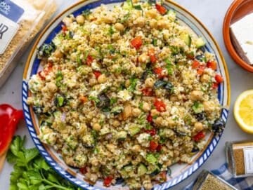 Step 4 Colorful Mediterranean bulgur salad served on a platter with feta and lemon.