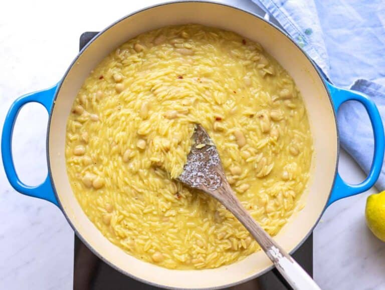 Step 4 Lemon zest, juice, and grated parmesan stirred into creamy orzo.