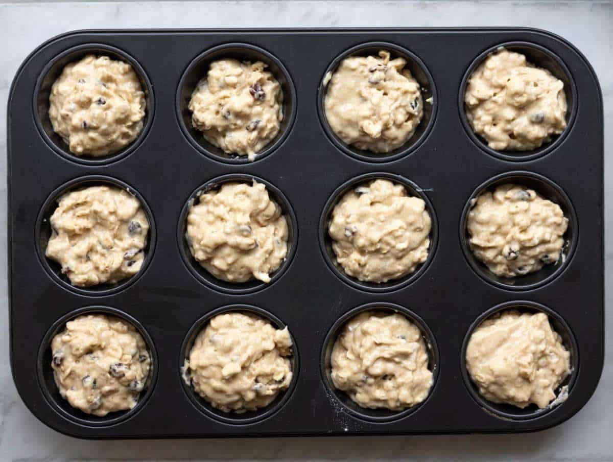 Step 4 Raisins folded into thick batter then spooned into muffin cups.