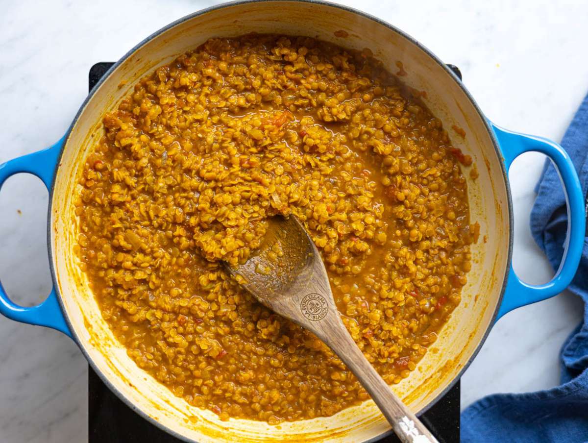 Step 4 Red lentils cooking in broth, gently bubbling and turning creamy.