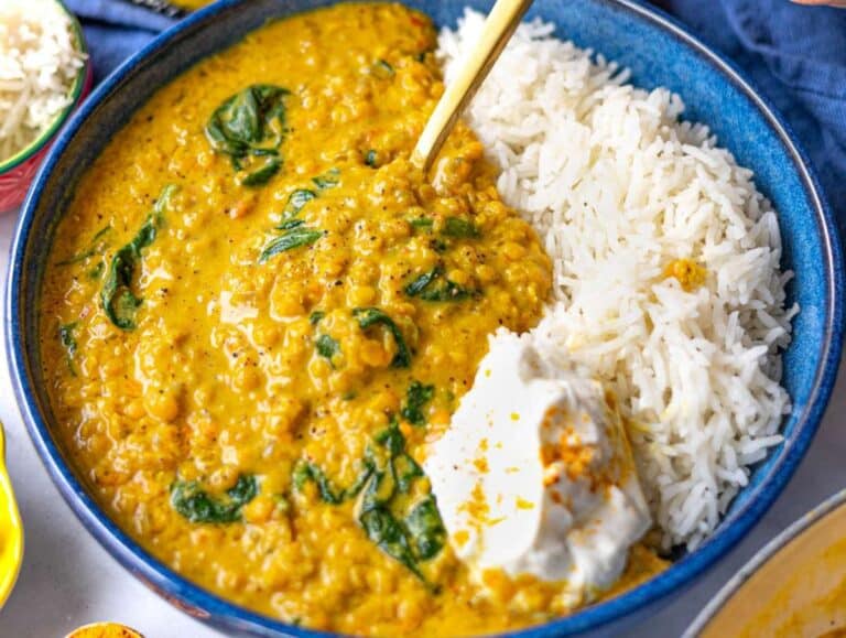 Step 6 Red lentil dal served in a bowl with lemon juice, basmati rice and yogurt.
